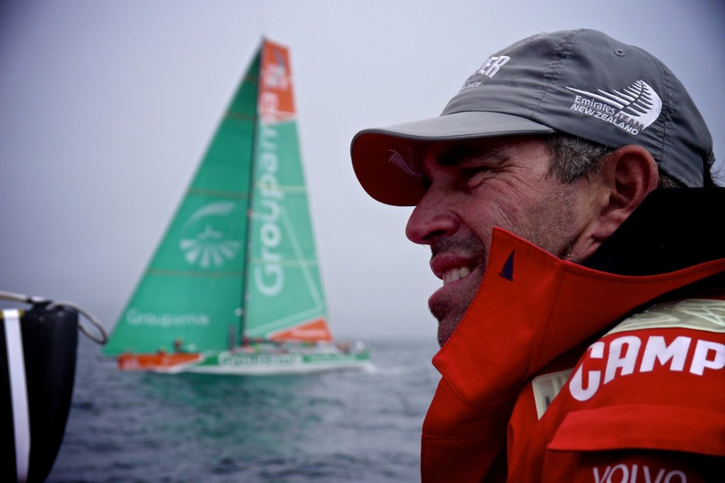 Camper’s Stu Bannatyne on the helm as they pass 2011-12 overall Volvo Ocean race winner, Groupama, on the way to win Leg 9 of the Volvo Ocean Race 2011-12 © Hamish Hooper/Camper ETNZ/Volvo Ocean Race